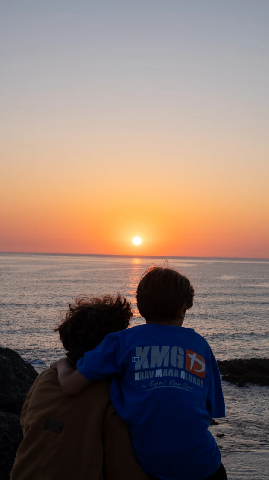 Deux silhouettes enlacées face au coucher de soleil